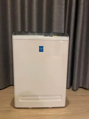 a white cooler sitting in front of a curtain at Luxury Condominium in Bangkok