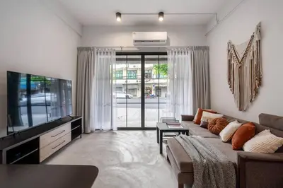 a living room with a couch and a flat screen tv at Sorrento Bangkok Old Town MRT Samyot in Bangkok