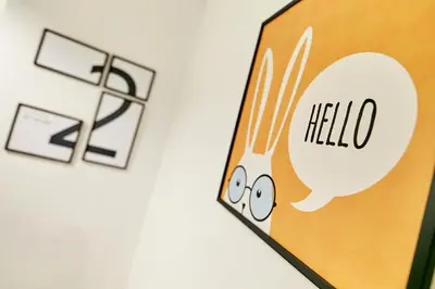 a sign that says hello with a picture of a plate of food at The rabbit's hole hostel in Bangkok