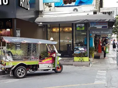 a golf cart parked in front of a white house at White House Asoke Sukhumvit 18 in Bangkok