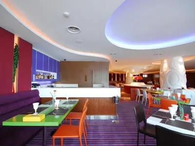 a restaurant with tables and chairs and a bar at Hip Hotel Bangkok in Bangkok