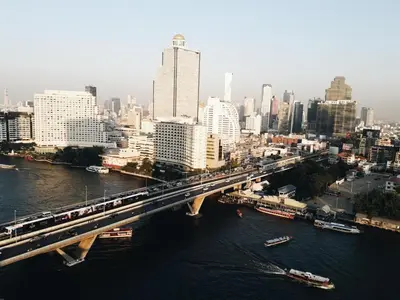 a bridge over a river with a train on it at KOWTHA RIVERTEL in Bangkok