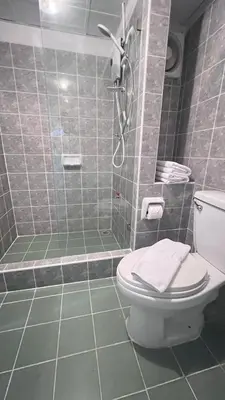 a bathroom with a shower with a toilet and a sink at We Resident in Ban Bang Toei (1)
