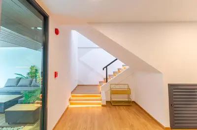 a room with a staircase with a bed and a window at \u66fc\u8c37\u8c6a\u534eIDEORama9\u8054\u6392\u522b\u5885 in Bangkok