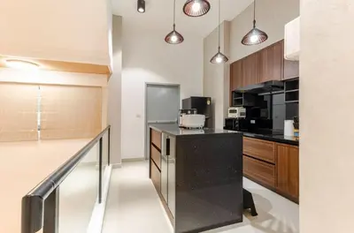 a kitchen with a black counter top and wooden cabinets at \u66fc\u8c37\u8c6a\u534eIDEORama9\u8054\u6392\u522b\u5885 in Bangkok