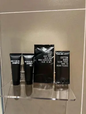 a shelf with three bottles ofconscious smoke on it at We Hotel in Ban Bang Toei (1)