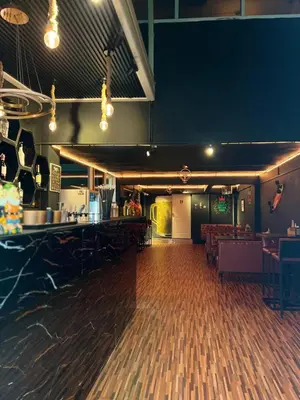an empty room with a bar and a dance floor at Lemon Tree Hostel Khaosan in Bangkok