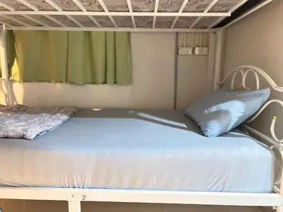 a bed in a room with a bunk bed at Lemon Tree Hostel Khaosan in Bangkok