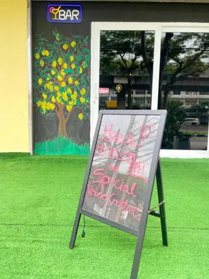 a sign in front of a building with a painting at Lemon Tree Hostel Khaosan in Bangkok