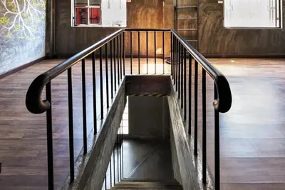 a staircase in a building with a metal railing at Vm1 Hostel in Bangkok