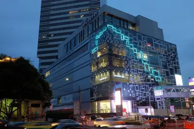 a tall building with blue lights on the side of it at OYO 225 Premier Place Bangkok in Bangkok