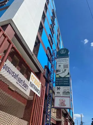 a building with signs on the side of it at Rest@Ratchada hotel in Bangkok
