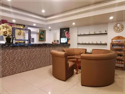 a bar in a restaurant with two chairs and a table at Rest@Ratchada hotel in Bangkok