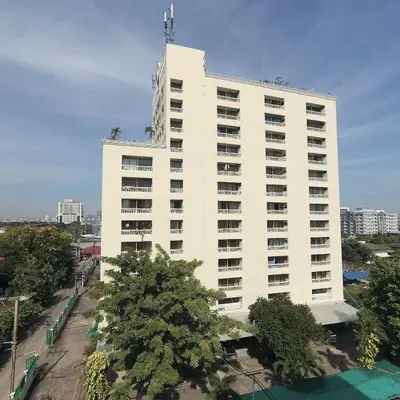 a large white building with trees in front of it at Omni Suites 1Bed #702A in Bangkok