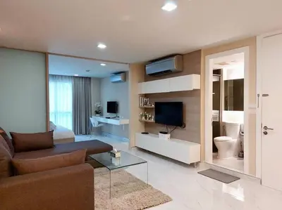 a living room with a couch and a tv in a room at Condominium - Sukhumvit Soi 5 BTS Nana- Room Size 47m2 in Bangkok