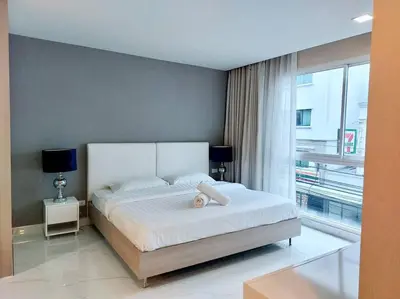 a bedroom with a bed and a large window at Condominium - Sukhumvit Soi 5 BTS Nana- Room Size 47m2 in Bangkok
