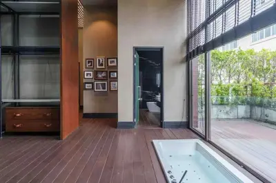 a bathroom with a bath tub and a large window at Luxury Pool Villa with Jacuzzi & Lift by Thonglor in Bangkok