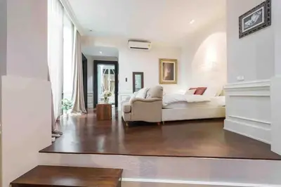 a living room with a couch and a fireplace at Luxury Pool Villa with Jacuzzi & Lift by Thonglor in Bangkok