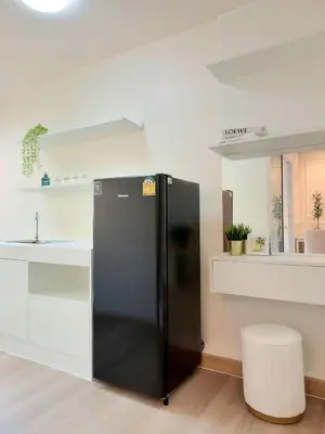 a black refrigerator in a kitchen with a sink at Joyful room in Ban Song Hong
