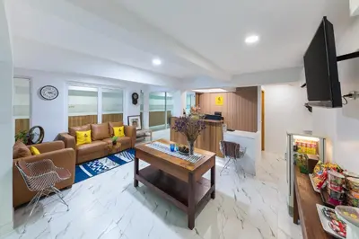 a living room with a couch and a table at Lee's Mark in Samutprakarn