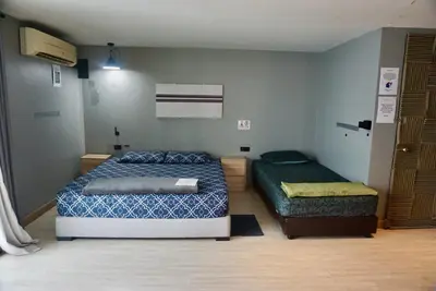 a bedroom with two beds in a room at Triple room at Hash Apartment Silom Soi 3 in Bangkok