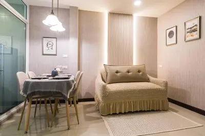a dining room with a table and a chair at BKK Sukumvit71 1 Bed 2 Bath 1 Living 1 Kitchen in Bangkok
