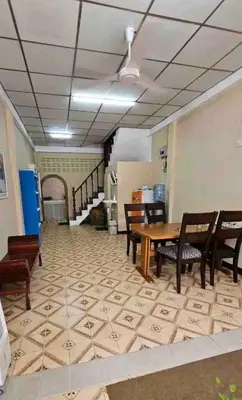 a room with a table and chairs and a staircase at DaHouse next to MRT Itsaraphap exit1 in Bangkok Yai