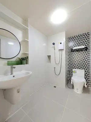 a bathroom with a sink and a toilet and a mirror at Joyful room in Ban Song Hong