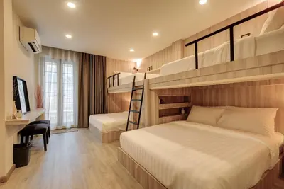 a bedroom with two bunk beds and a desk at Potji's private apartment in Bang Su