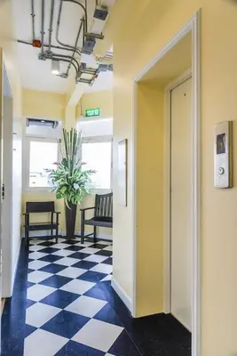 an office hallway with a checkered floor at Lamoon Vivit in Bangkok