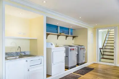a kitchen with two washer and dryers and a staircase at Lamoon Vivit in Bangkok