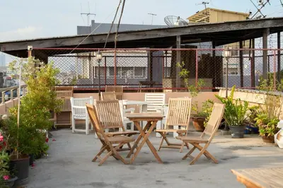 a wooden table and chairs on a patio at Lamoon Vivit in Bangkok