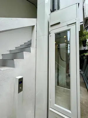 a glass door on the side of a building at AVALAN PhayaThai airport link in Pratunam