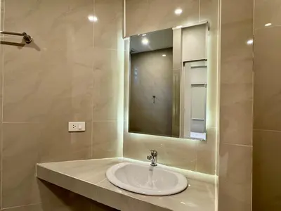 a bathroom with a sink and a mirror at AVALAN PhayaThai airport link in Pratunam