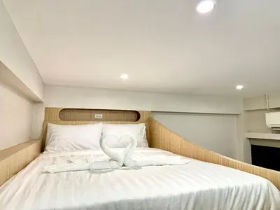 a bed with a heart decoration on top of it at AVALAN PhayaThai airport link in Pratunam