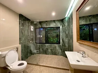 a bathroom with a shower and a toilet and a sink at AVALAN PhayaThai airport link in Pratunam