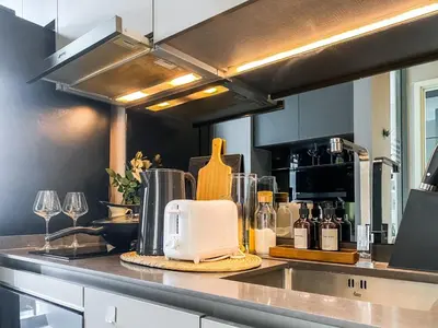 a kitchen counter with a toaster and wine glasses at Magnificent Apt 1BR - Ultra Fast WiFi - Ekkamai in Bangkok
