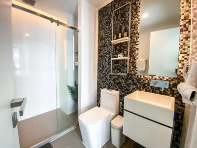 a bathroom with a toilet and a sink and a shower at Magnificent Apt 1BR - Ultra Fast WiFi - Ekkamai in Bangkok