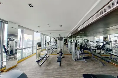 a gym with treadmills and machines in a building at Urban High-Rise - Ultra Fast WiFi - BTS Phrom Phong in Bangkok