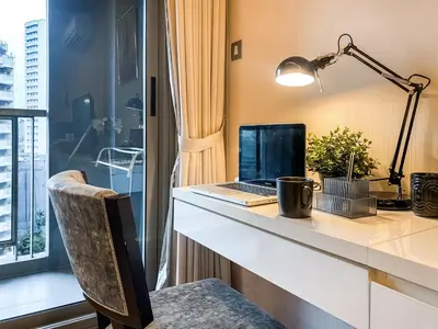 an office with a desk with a laptop computer on it at Urban High-Rise - Ultra Fast WiFi - BTS Phrom Phong in Bangkok
