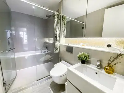 a bathroom with a toilet and a sink and a shower at Urban High-Rise - Ultra Fast WiFi - BTS Phrom Phong in Bangkok
