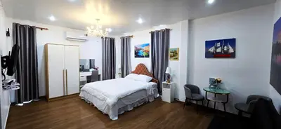 a bedroom with a bed and a desk and a table at Tiny Island Lake Lodge in Bangkok