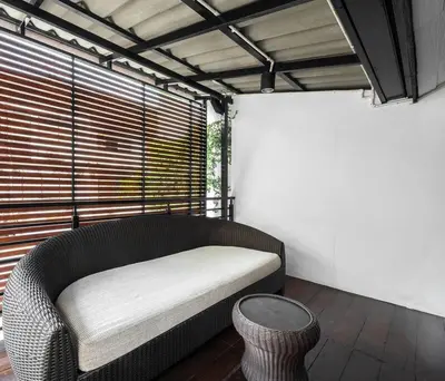 a couch sitting in a room with a window at 499 House Villa in Bangkok