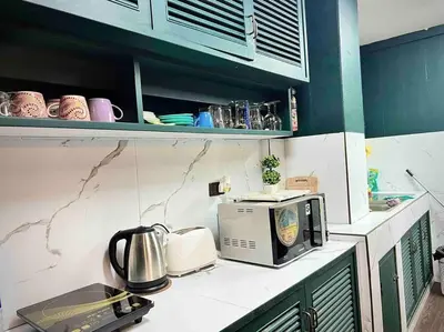 a kitchen with a toaster and a microwave on a counter at 5BR House BTSNana Nanaplaza City center MBK Center world in Bangkok