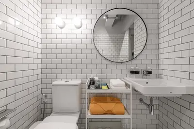 a bathroom with a toilet and a sink and a mirror at Mowa Bangkok in Bangkok