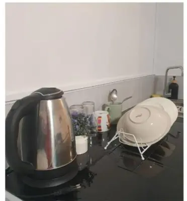 a kitchen counter with a tea kettle on a stove at Popular Muang Thong Thani Condo, Building T9, Floor 4, Room 36 in Thung Si Kan