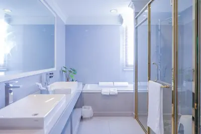 a white bathroom with a sink and a shower at Sukhumvit-Thonglor Luxury Pool Club Villa 5 Mins to BTS \u7d20\u5764\u9038-\u901a\u7f85 \u8c6a\u83ef\u6703\u6240\u6cf3\u6c60\u5225\u5885 5\u5206\u9418\u5230\u9054\u5730\u9435 in Bangkok