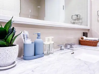 a bathroom counter with a sink and a bottle of soap at Sukhumvit-Thonglor Luxury Pool Club Villa 5 Mins to BTS \u7d20\u5764\u9038-\u901a\u7f85 \u8c6a\u83ef\u6703\u6240\u6cf3\u6c60\u5225\u5885 5\u5206\u9418\u5230\u9054\u5730\u9435 in Bangkok