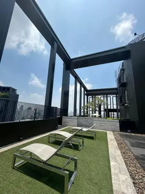 two chairs and a table on top of a building at 1BR at Thonglor BTS InfinityPool overlooking city in Bangkok