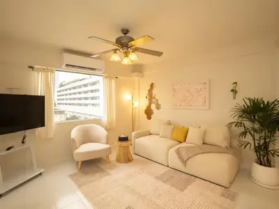 a living room with a couch and a ceiling fan at Cozy 2-bedroom apartment in Silom city center - 6A in Bang Rak